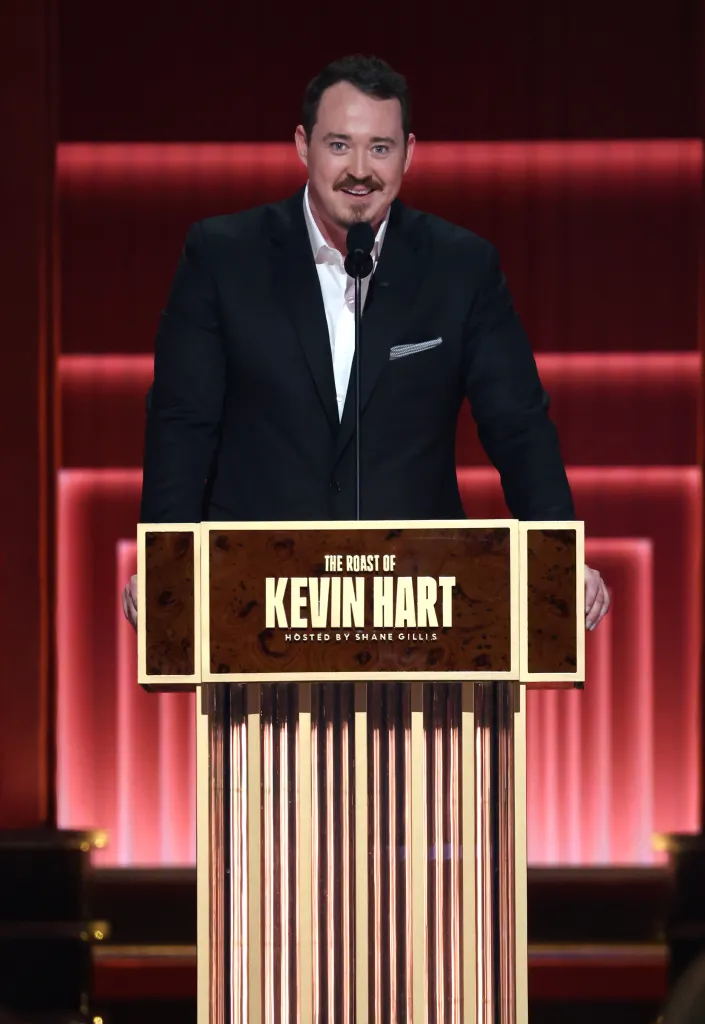 Shane Gillis speaking onstage during 