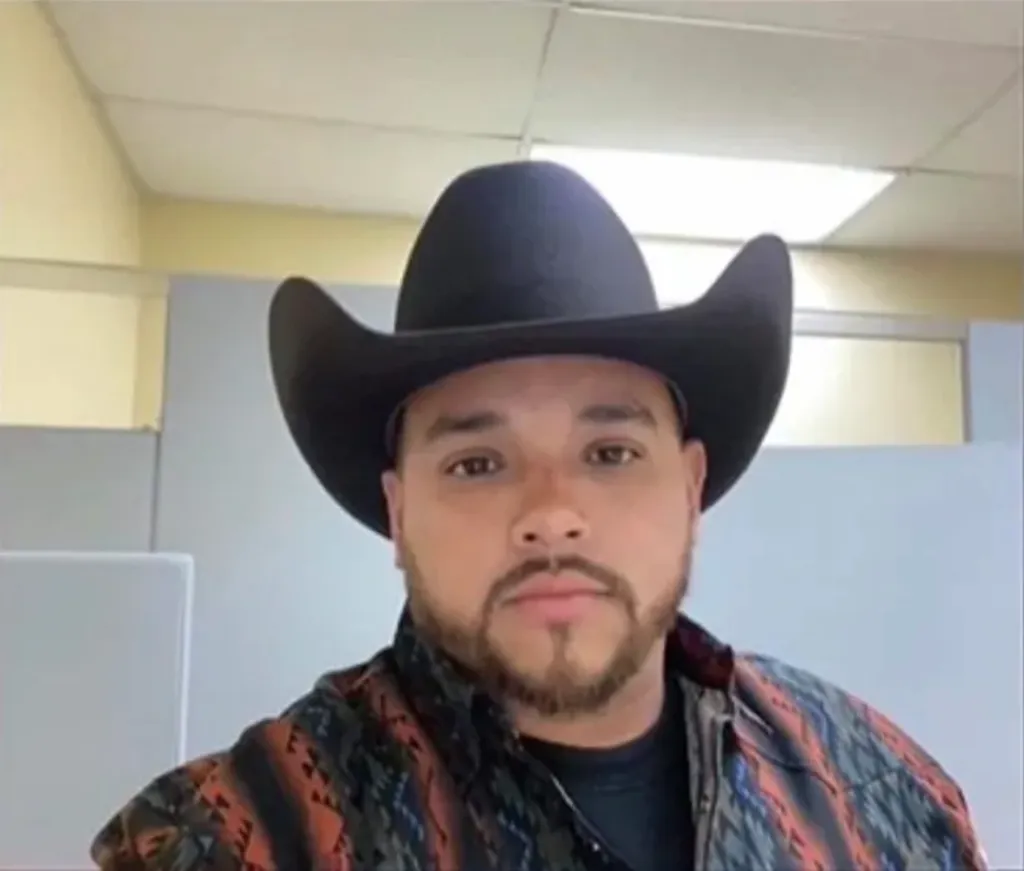 Luis Caillas, a man with a goatee and wearing a black cowboy hat and patterned shirt.