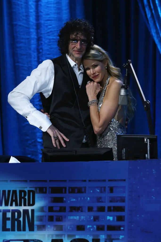 Howard Stern and Beth Ostrosky Stern pose for a photo at a birthday bash.