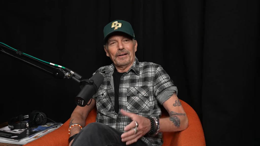 Billy Bob Thornton smiling while being interviewed for a podcast.