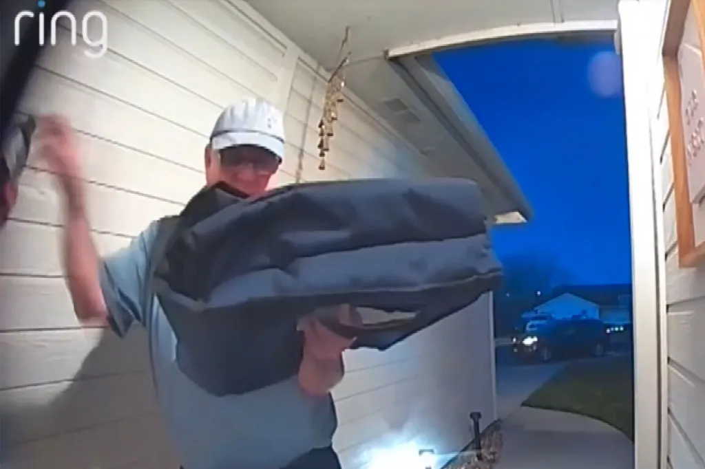 Pizza delivery driver holding a pizza delivery bag with a Diet Coke.