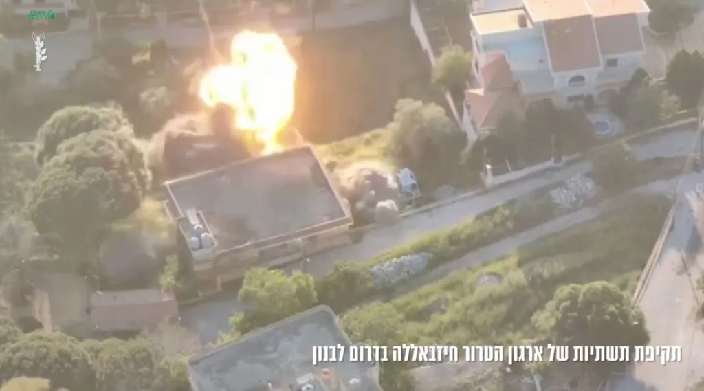 Overhead view of a building exploding in a residential area.