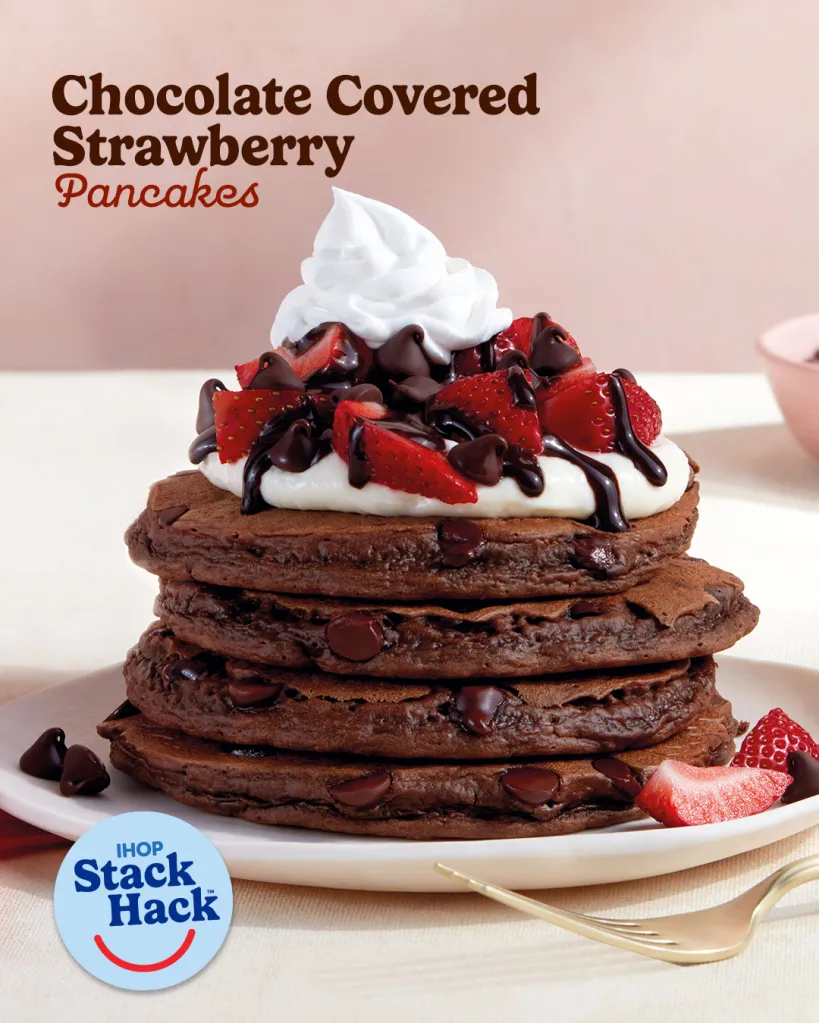 Chocolate Covered Strawberry Pancakes with whipped cream, chocolate chips, and syrup.