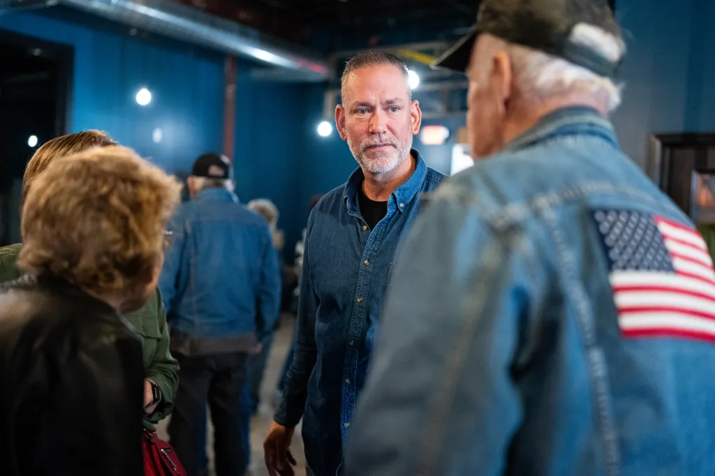 Independent Senate candidate Dan Osborn speaks with attendees at a campaign stop.