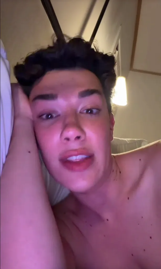 James Charles looking into the camera, bathed in purple light.