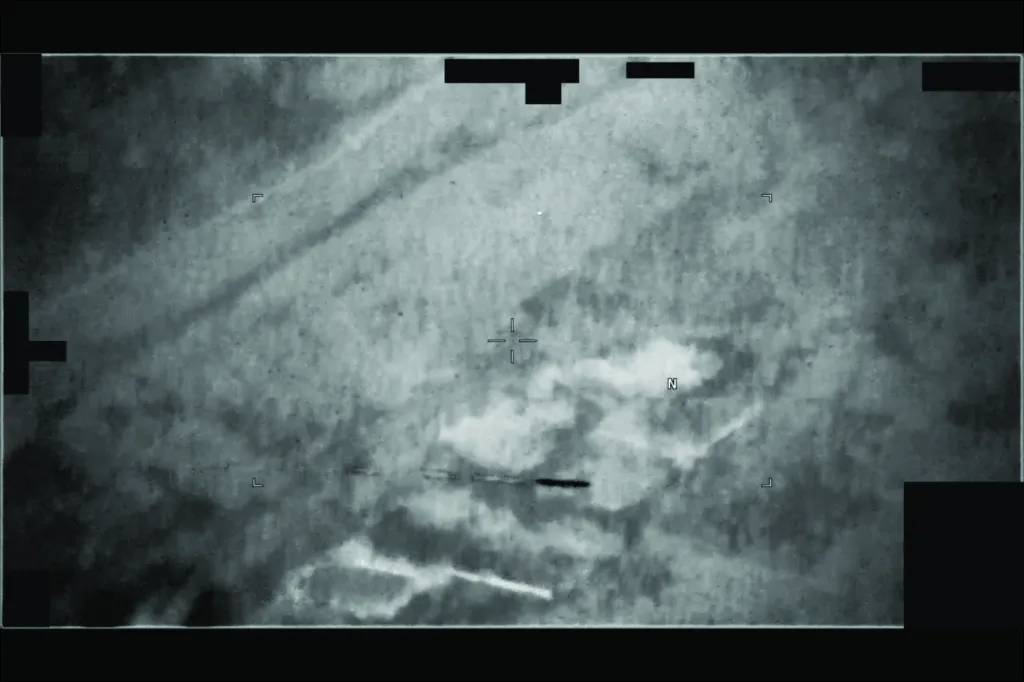 Still from a video featuring a UAP flying across a military screen.
