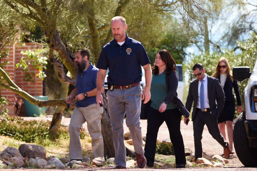Investigators from the FBI examine the residence of Nancy Guthrie.
