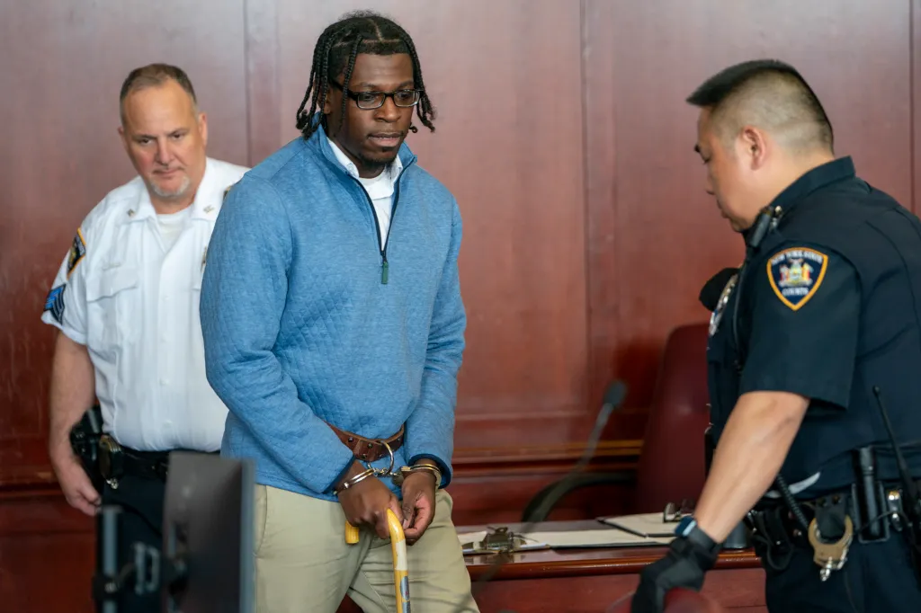 He was in a blue top and light brown pants in court Thursday.