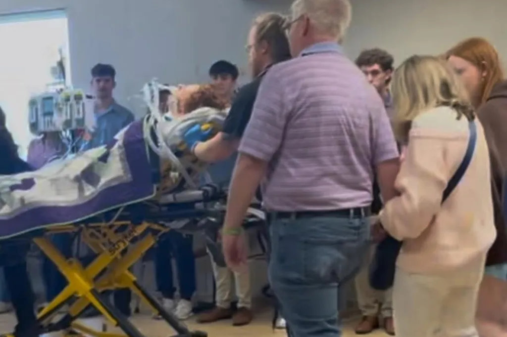 Jack Fleischaker, 19, on a stretcher with medical personnel and bystanders after being critically injured.