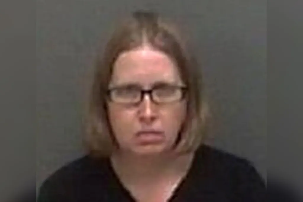 Mugshot of Jaclyn Skuce, a white woman with light brown hair, wearing glasses and a black top.