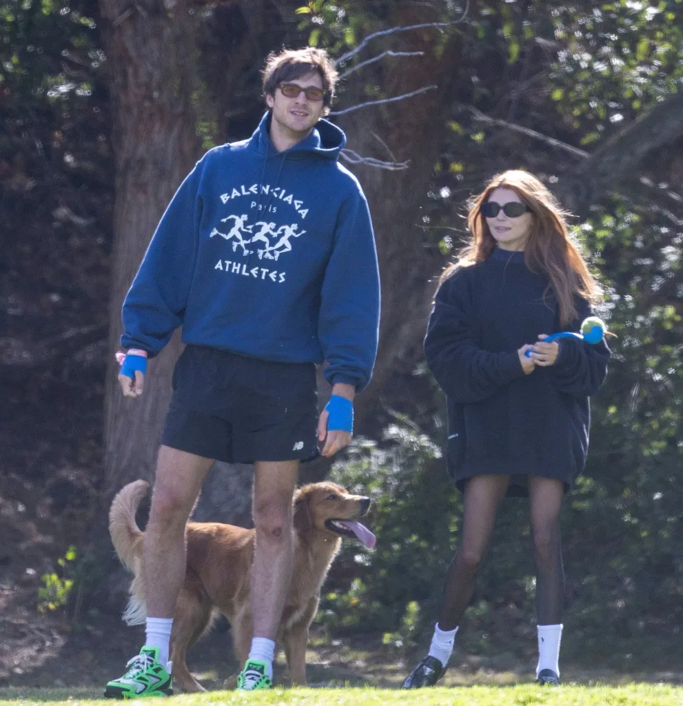 Jacob Elordi and Olivia Jade Giannulli at a dog park with a golden retriever.