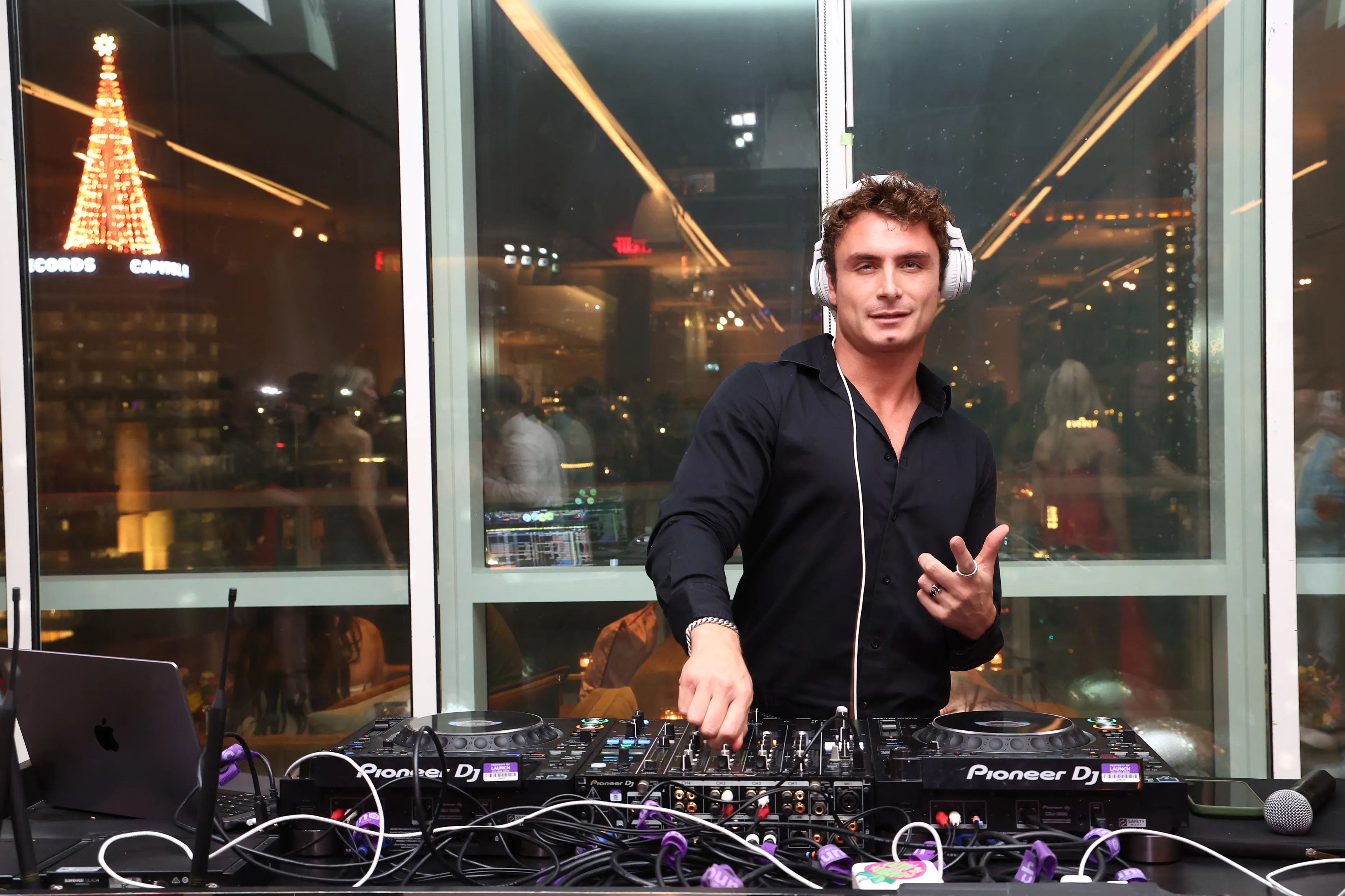 James Kennedy performing as a DJ during the Pups Without Borders 5 Year Anniversary Holiday Party.