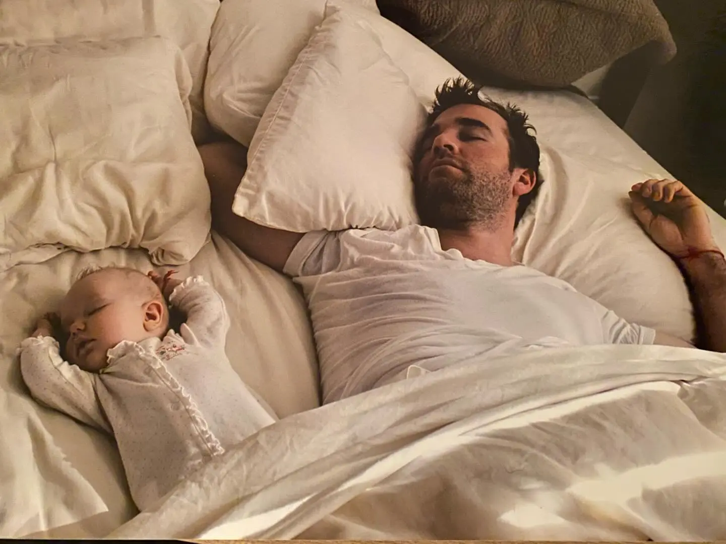 James Van Der Beek sleeping next to his baby.