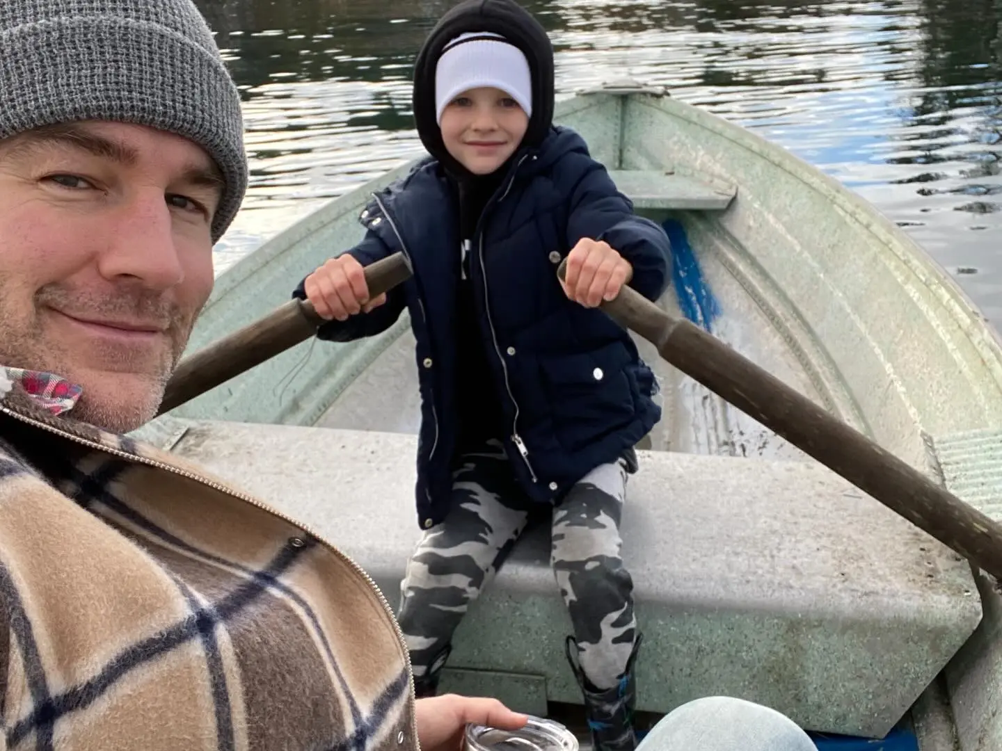 James Van Der Beek and child in a rowboat.