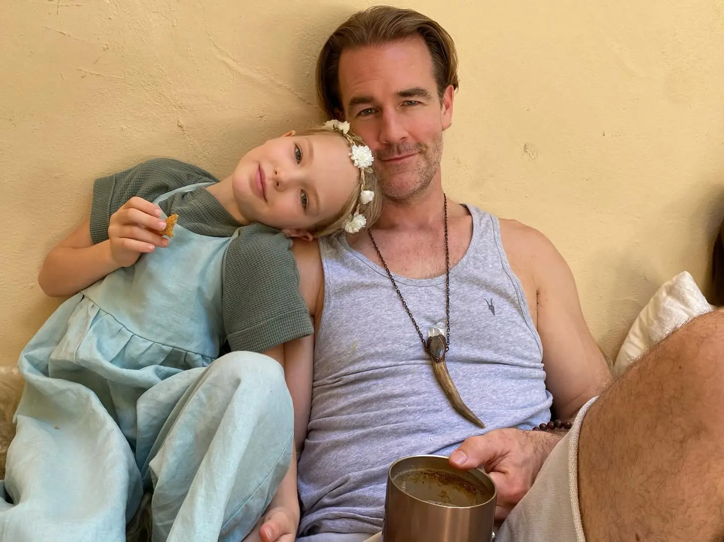 James Van Der Beek with his young daughter, both smiling at the camera.