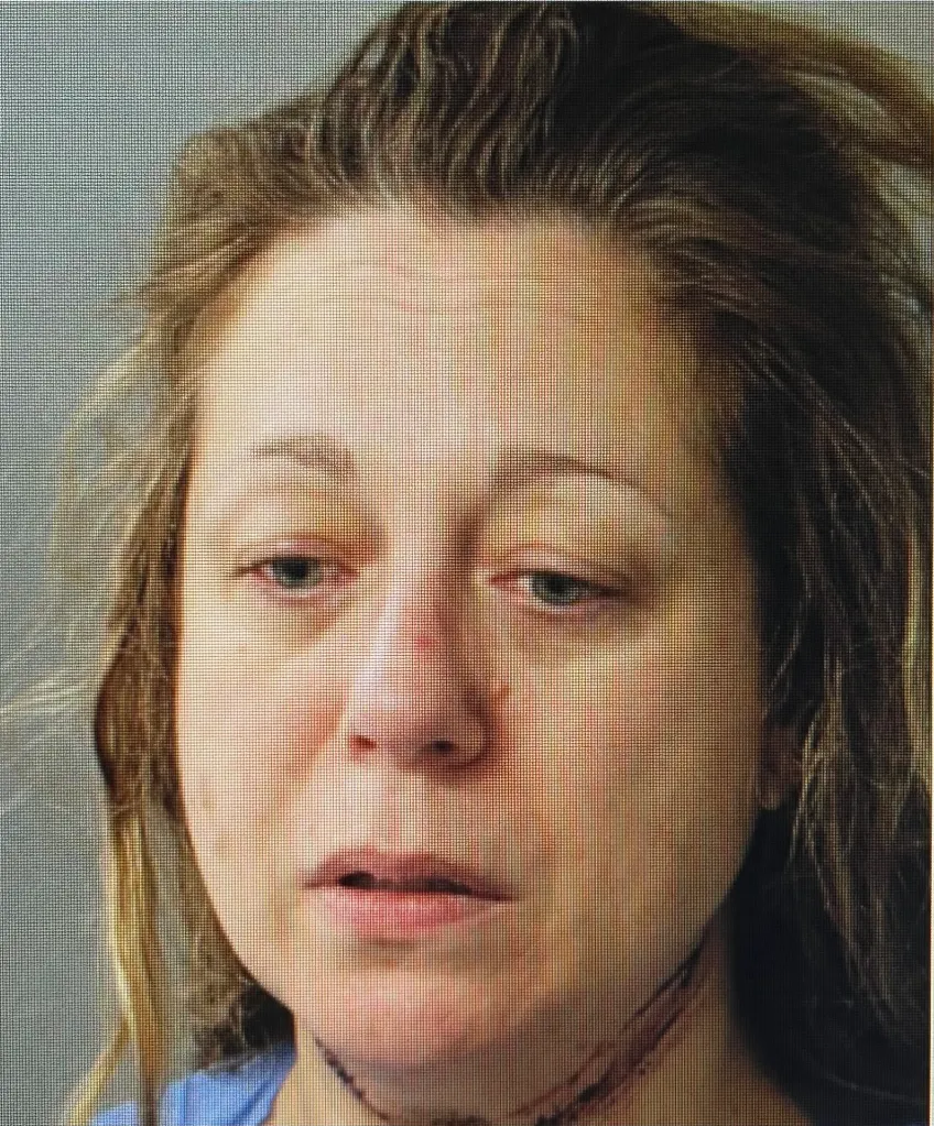 Janette MacAusland seen in her mugshot with disheveled hair and marks on her neck