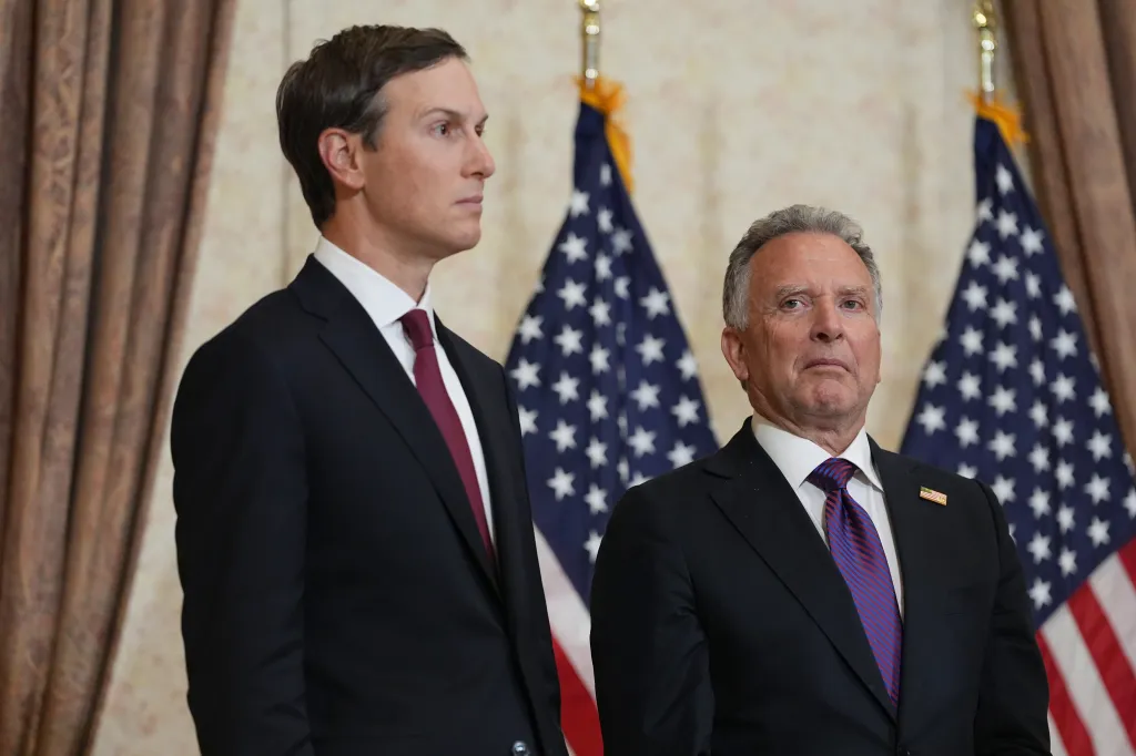 Jared Kushner and Steve Witkoff standing in front of US flags.