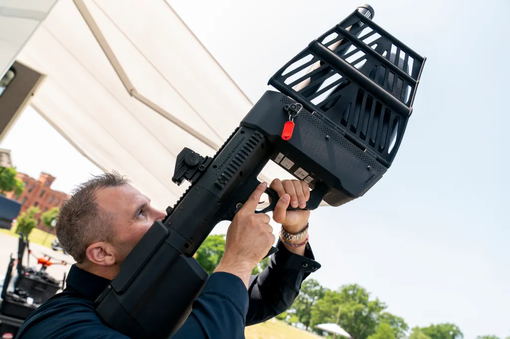 Jarred Pennington simulates using a directional jammer mitigation tool to take down a drone.