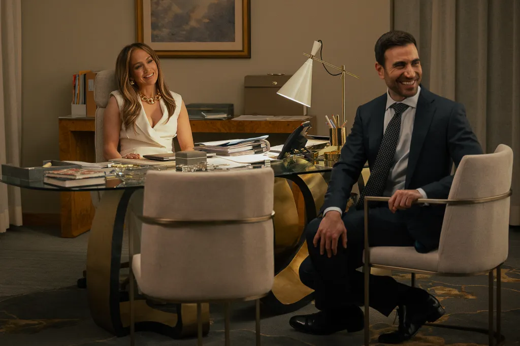 Jackie Cruz and Daniel Blanchflower sitting at a large desk and smiling.
