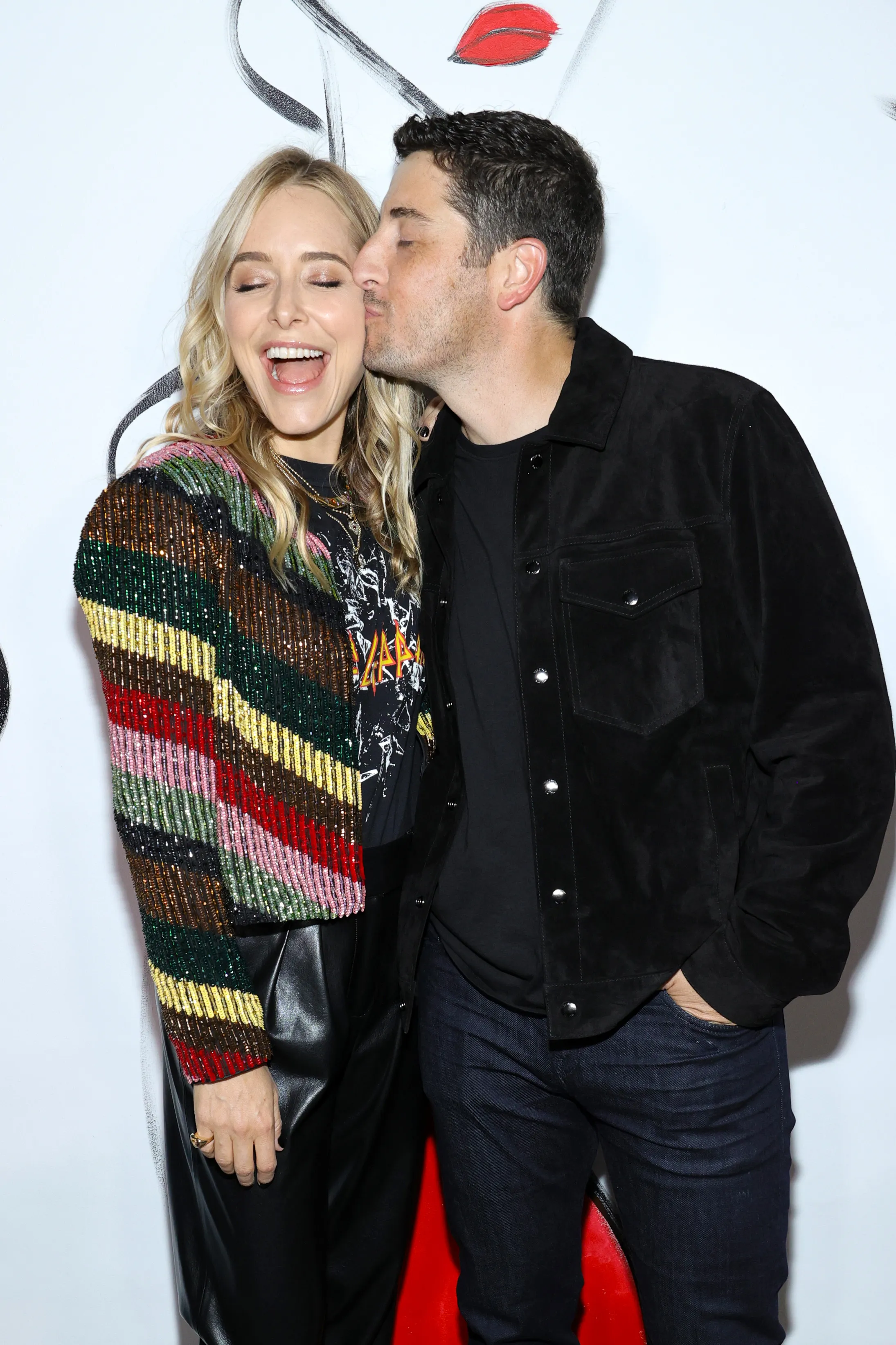 Jason Biggs kissing Jenny Mollen on the cheek at New York Fashion Week.