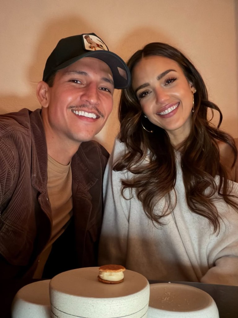 Jessica Alba and Danny Ramirez smiling for a selfie.