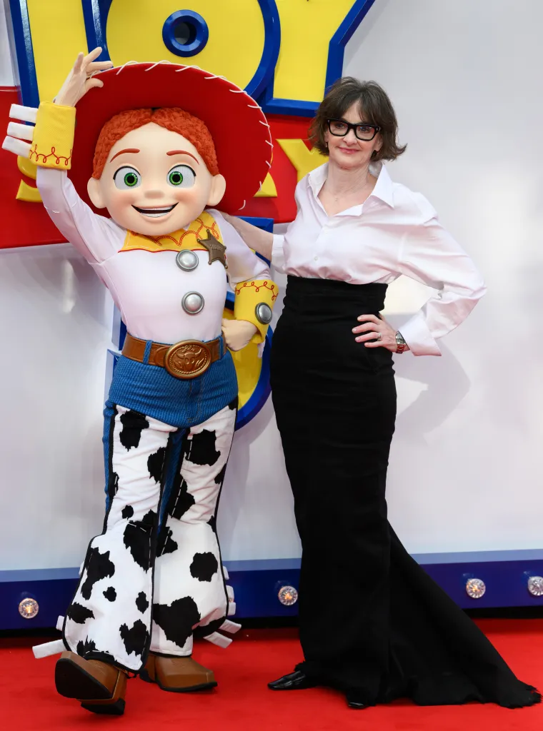 Actress Joan Cusack posing with a person in a Jessie costume from Toy Story at the 