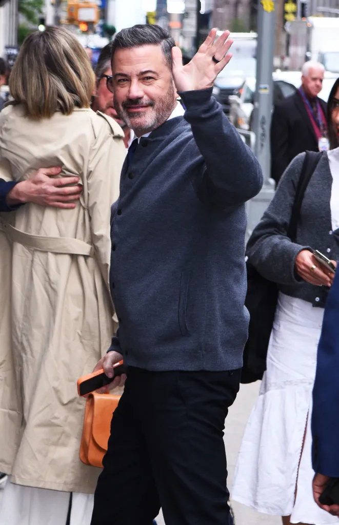 Jimmy Kimmel waves to the camera while arriving at The Late Show with Stephen Colbert.