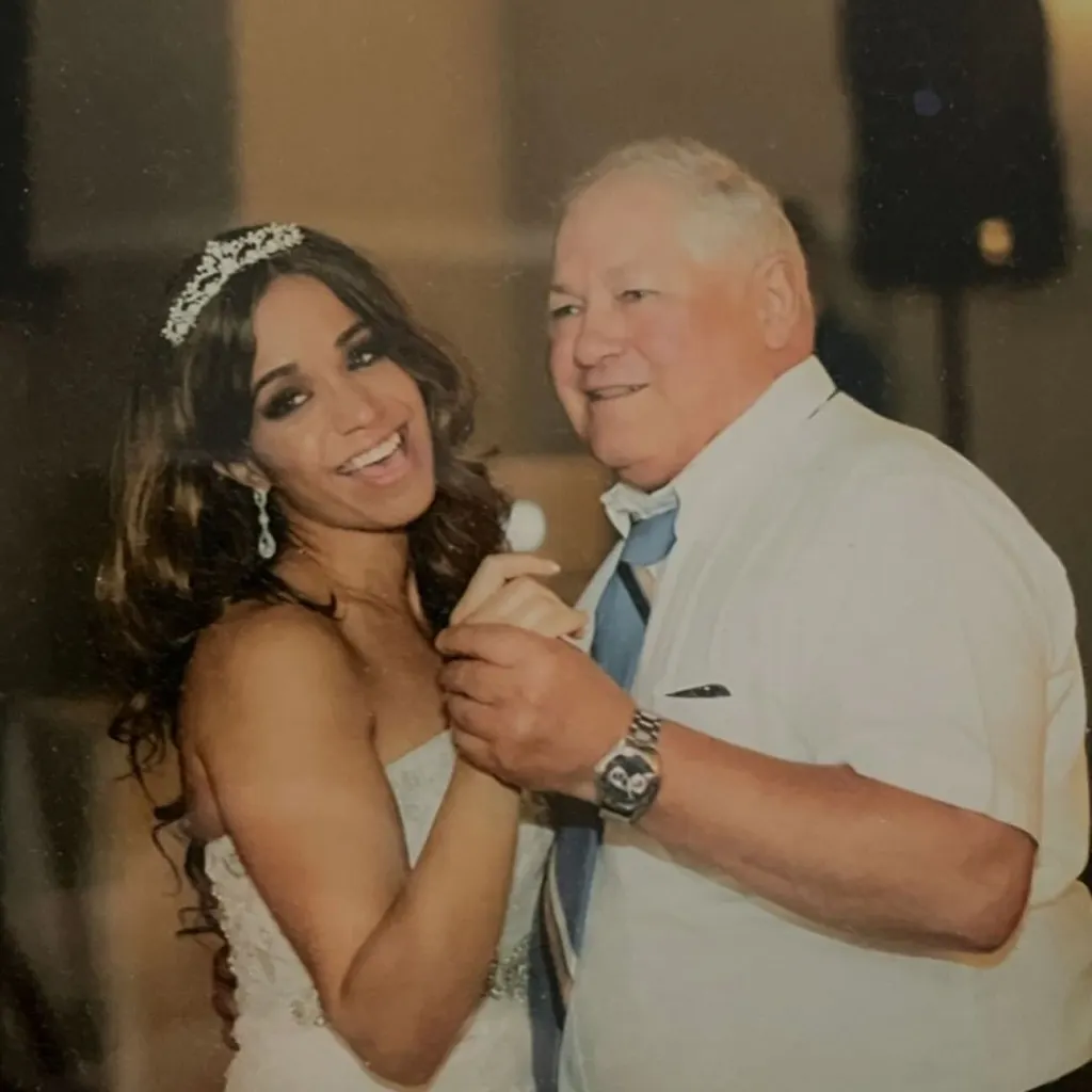 A man and a woman in a wedding dress dancing.