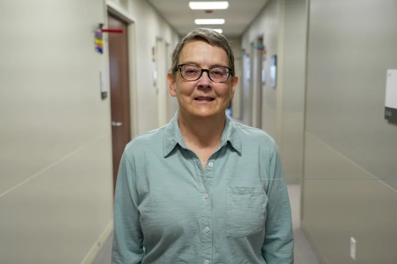 Jodi Graf, a NASA engineer and mother, standing in a hallway.