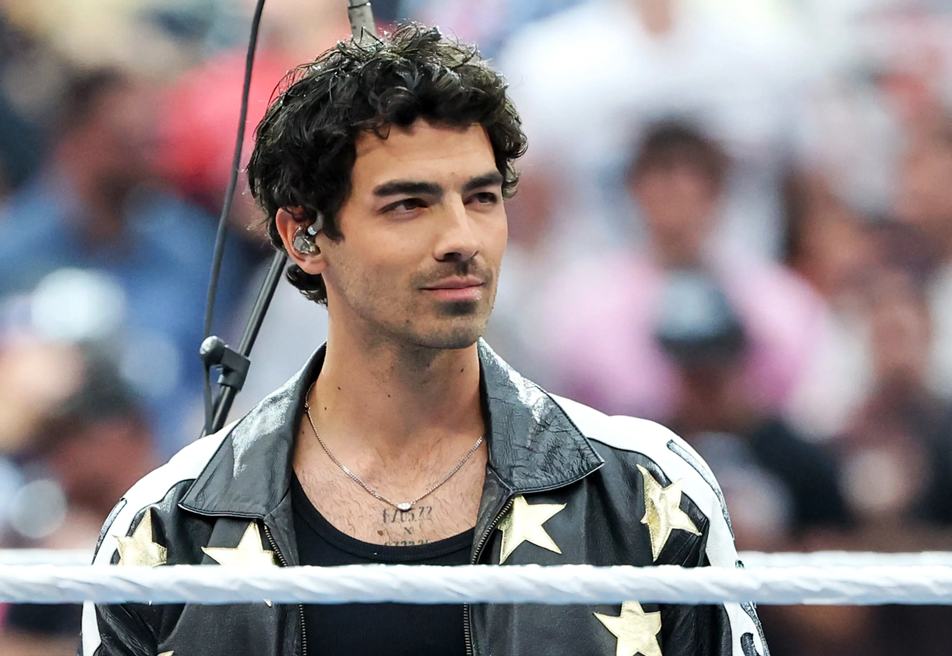 Joe Jonas prepares to perform the US national anthem before WrestleMania 42.