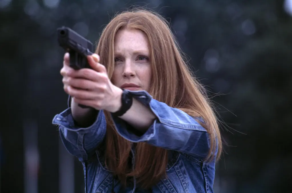 Julianne Moore as Clarice Starling in Hannibal aiming a gun.