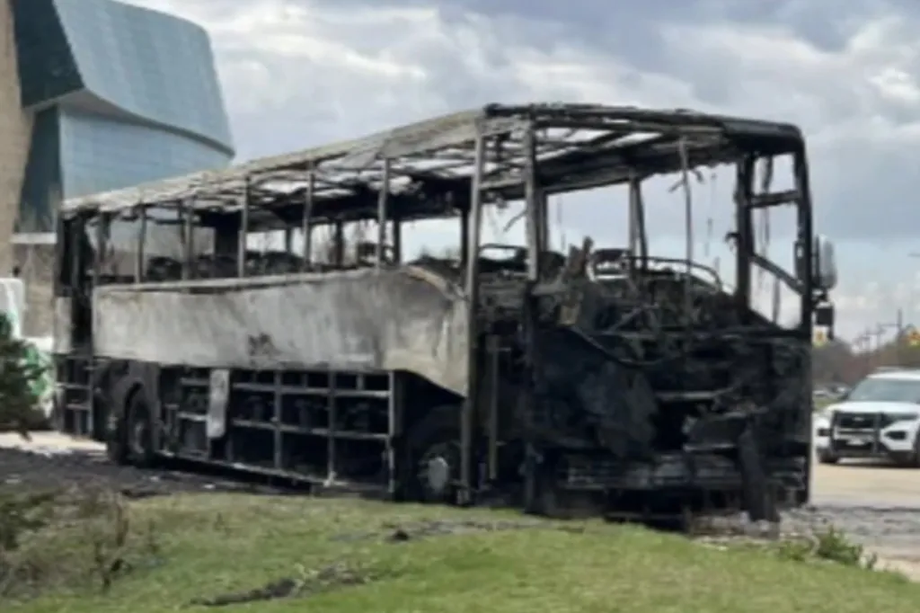 A charter bus, charred and destroyed by an arson fire.