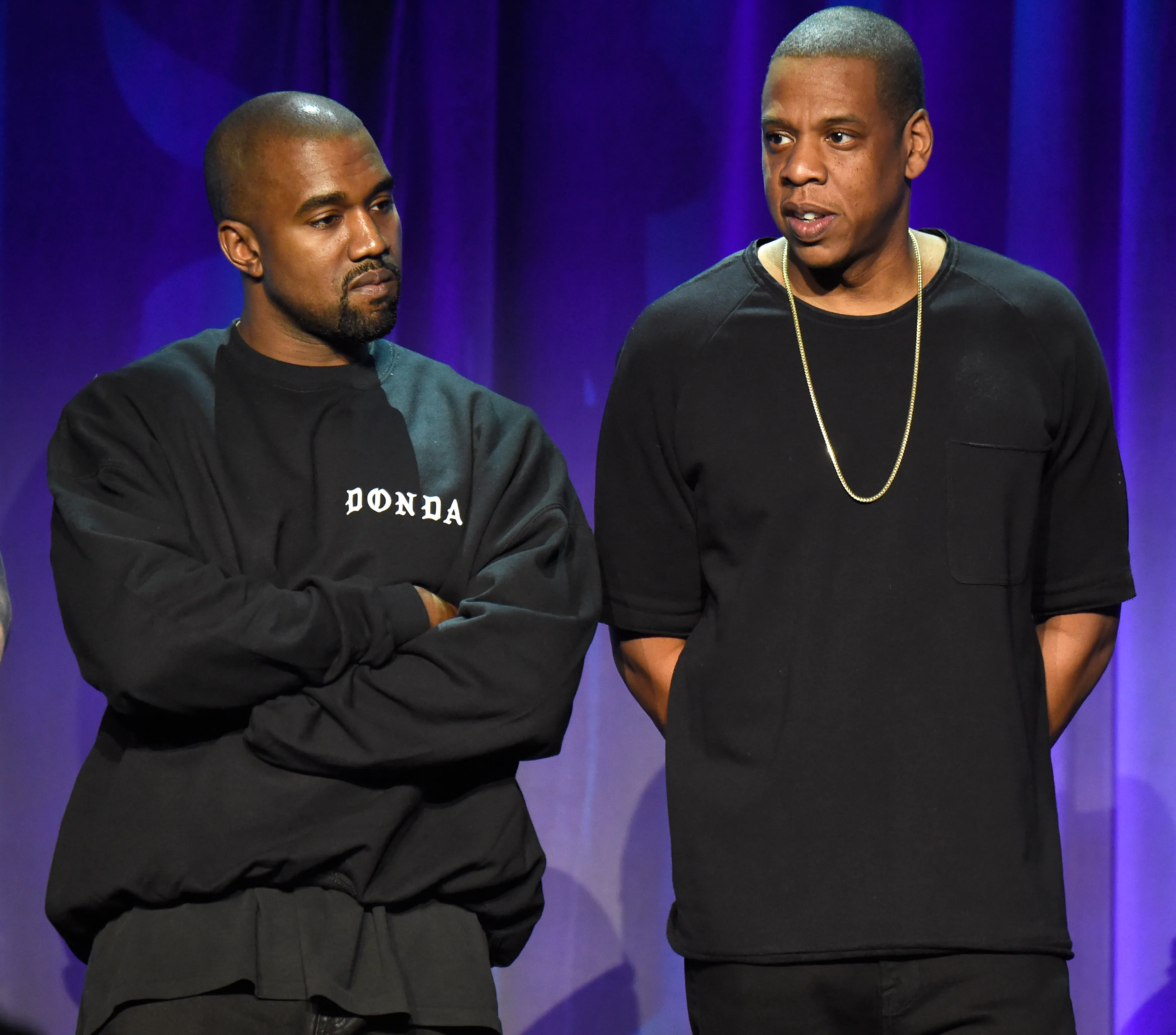 Kanye West and Jay-Z standing on stage.