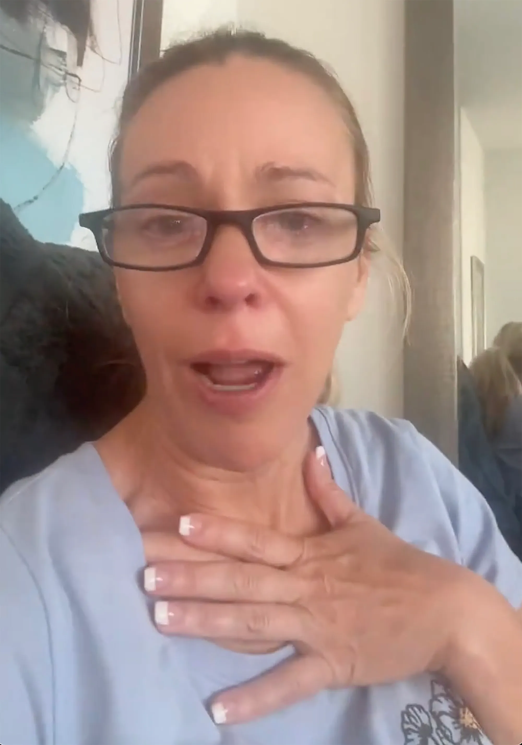 Kate Gosselin looking stressed with her hand on her chest.