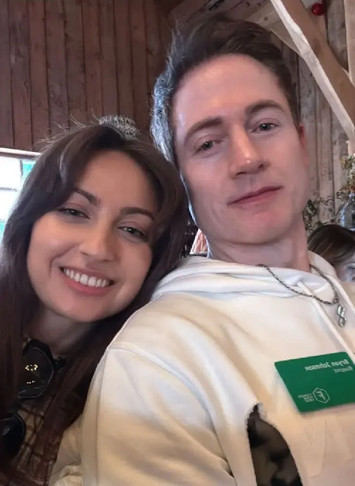 Kate Tolo and Bryan Johnson smiling for a selfie.