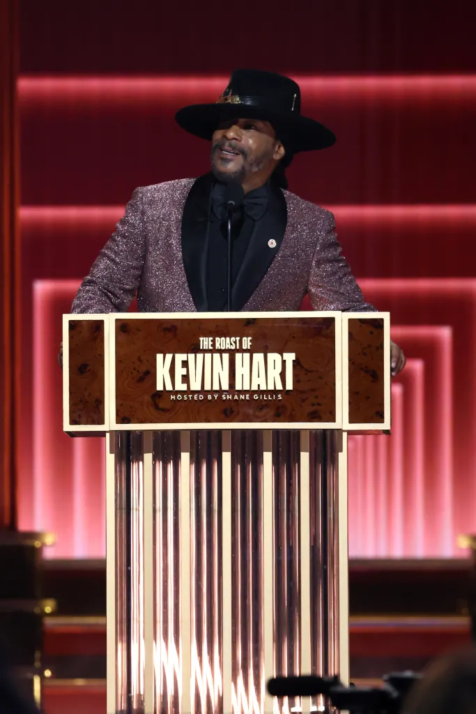 Katt Williams speaking at a podium with 
