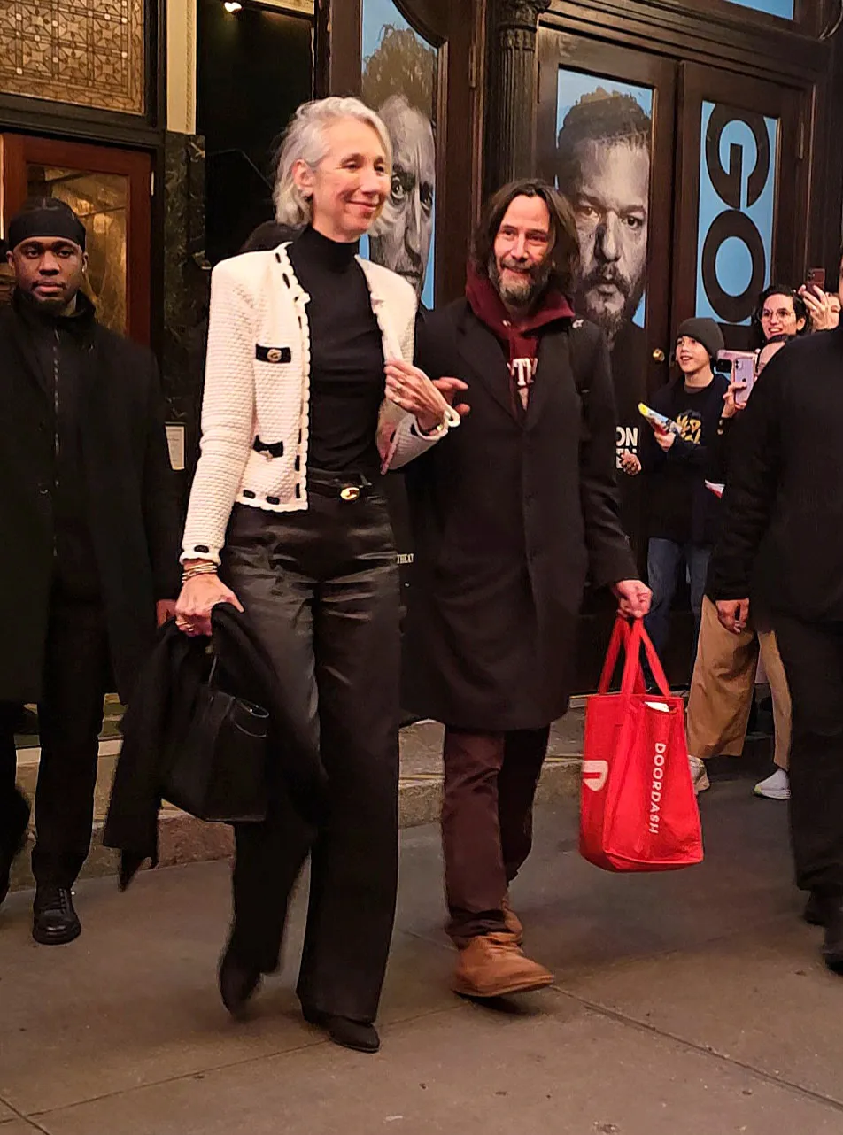 Alexandra Grant and Keanu Reeves walking hand-in-hand after a performance of 