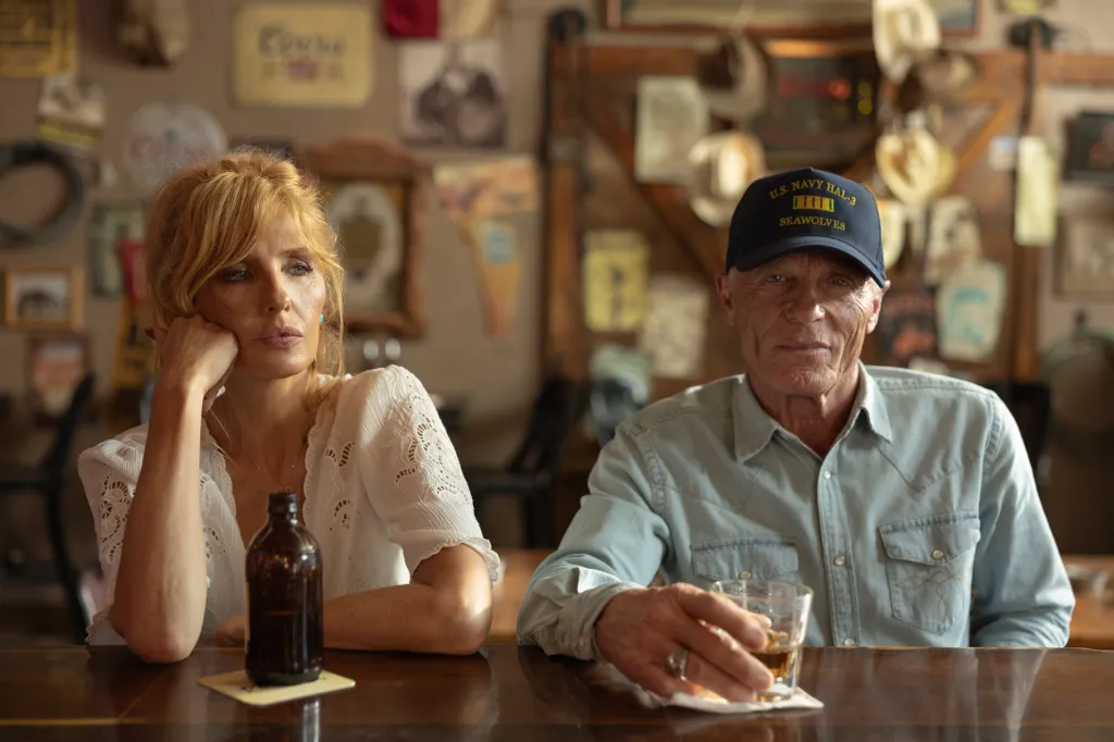 Kelly Reilly as Beth Dutton and Ed Harris as Everett McKinney sit at a bar.