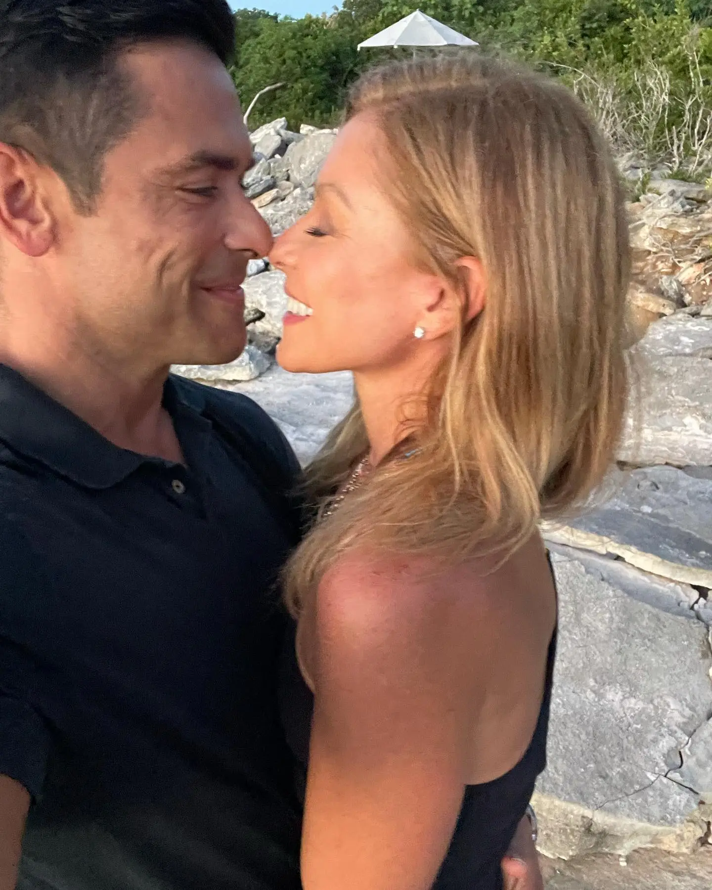 Kelly Ripa and Mark Consuelos almost touching noses.