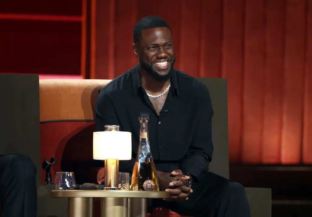 Kevin Hart smiles while sitting on stage at Netflix Is A Joke Festival Presents: The Roast of Kevin Hart.