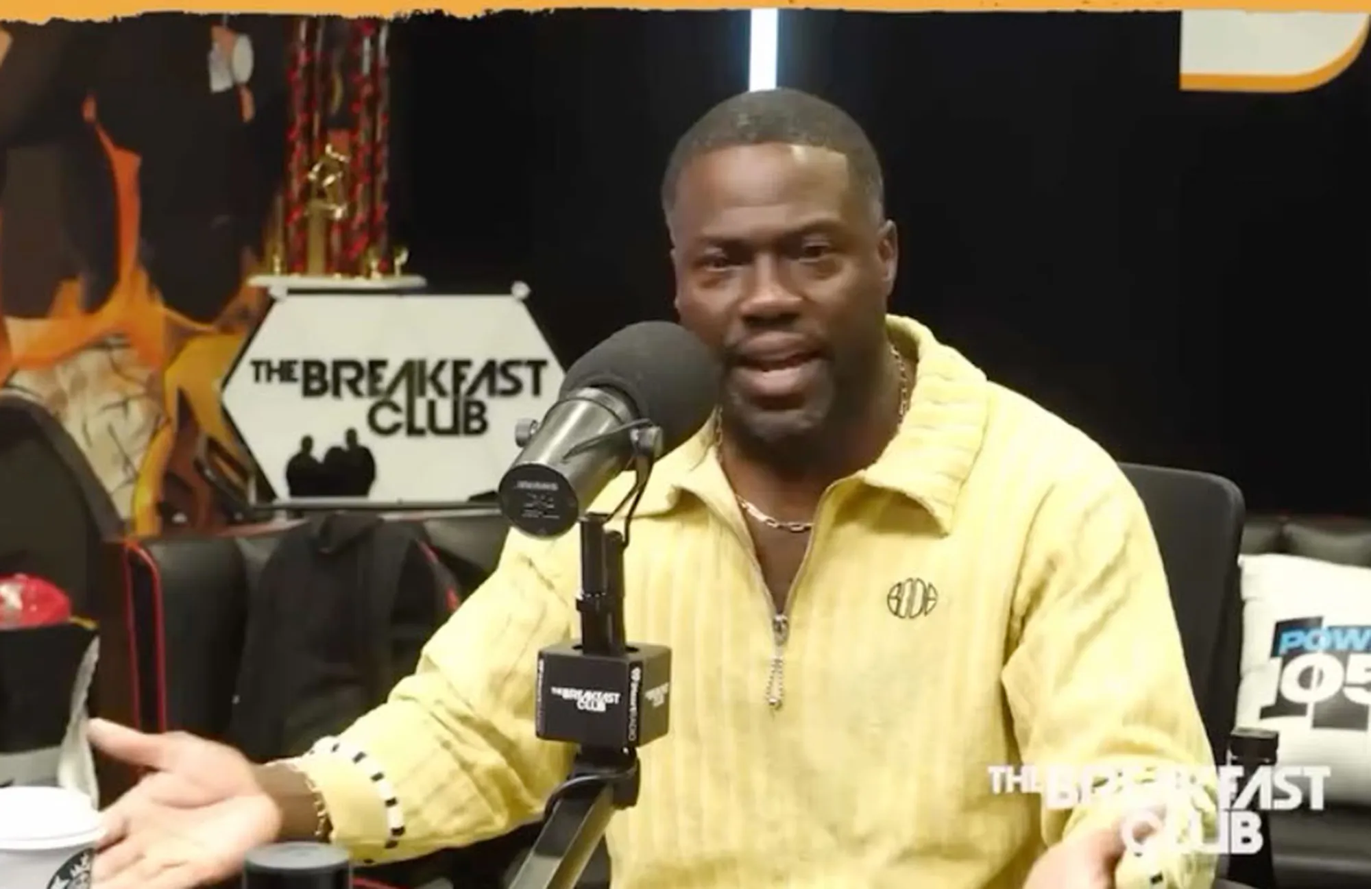 Kevin Hart speaking into a microphone on 