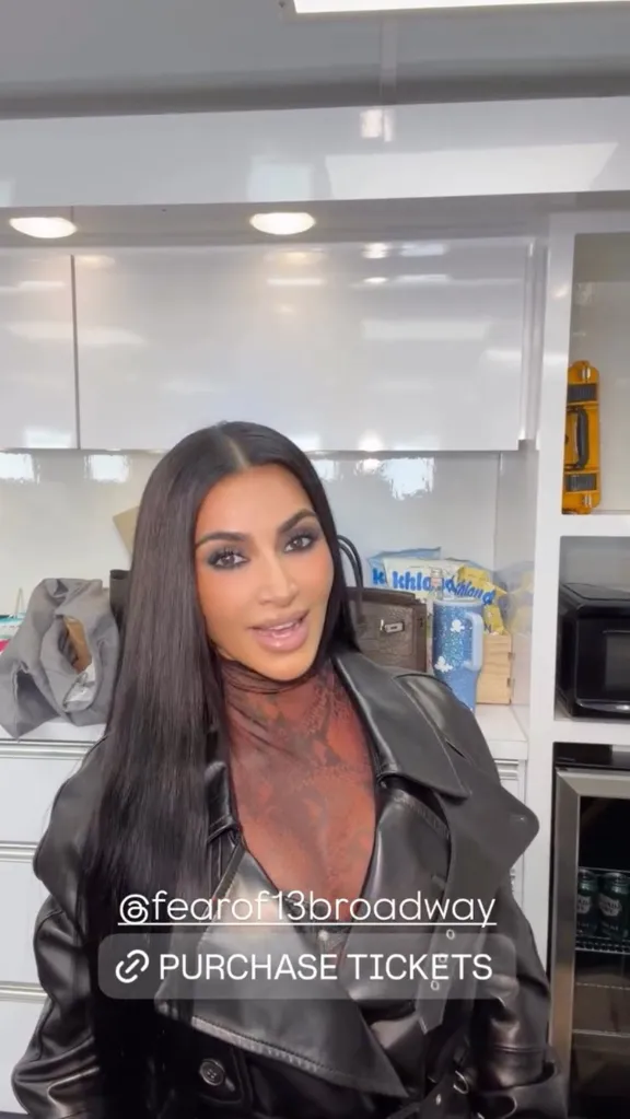 Kim Kardashian in a black leather jacket and a dark red patterned top, with an Instagram story link to purchase tickets for @fearof13broadway.