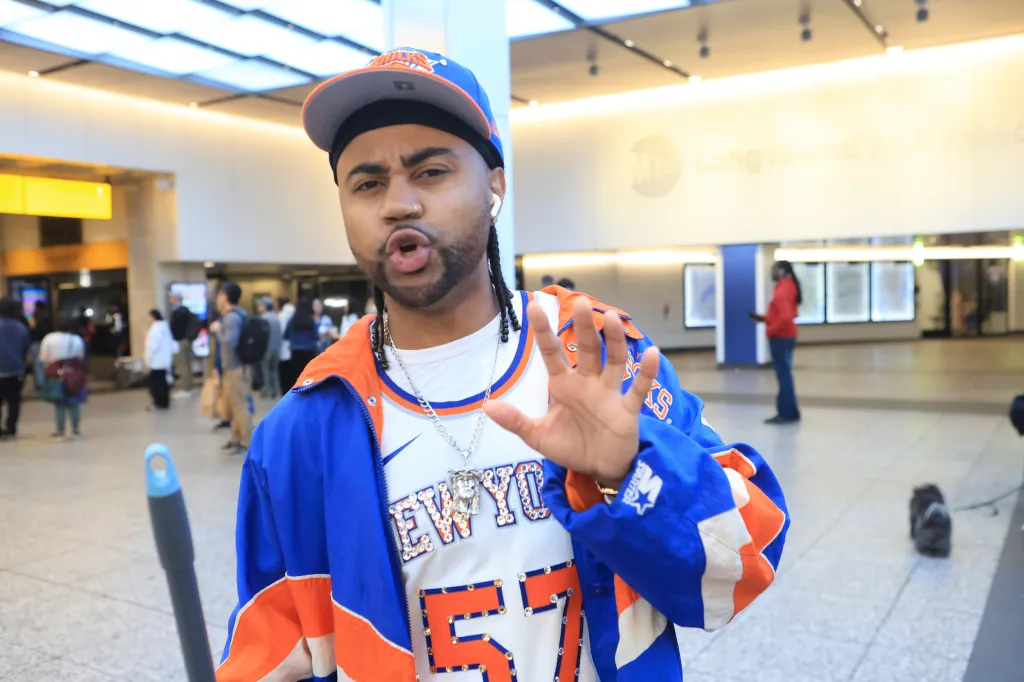 Knicks fan Marcellus Brown gesturing at Penn Station.