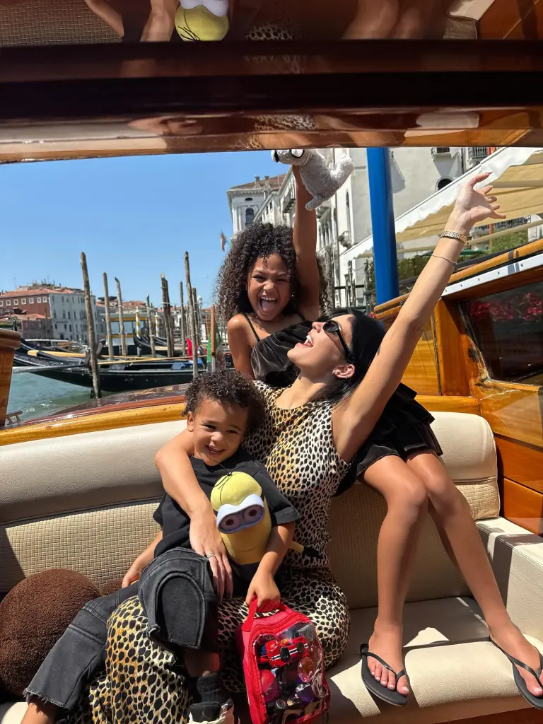 Kylie Jenner and her children, Stormi and Aire, on a boat in Venice.
