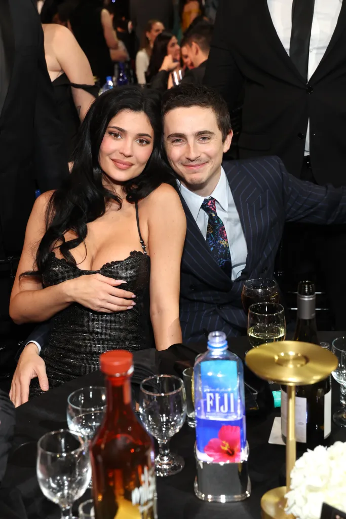 Kylie Jenner and Timothée Chalamet sitting together at a table.