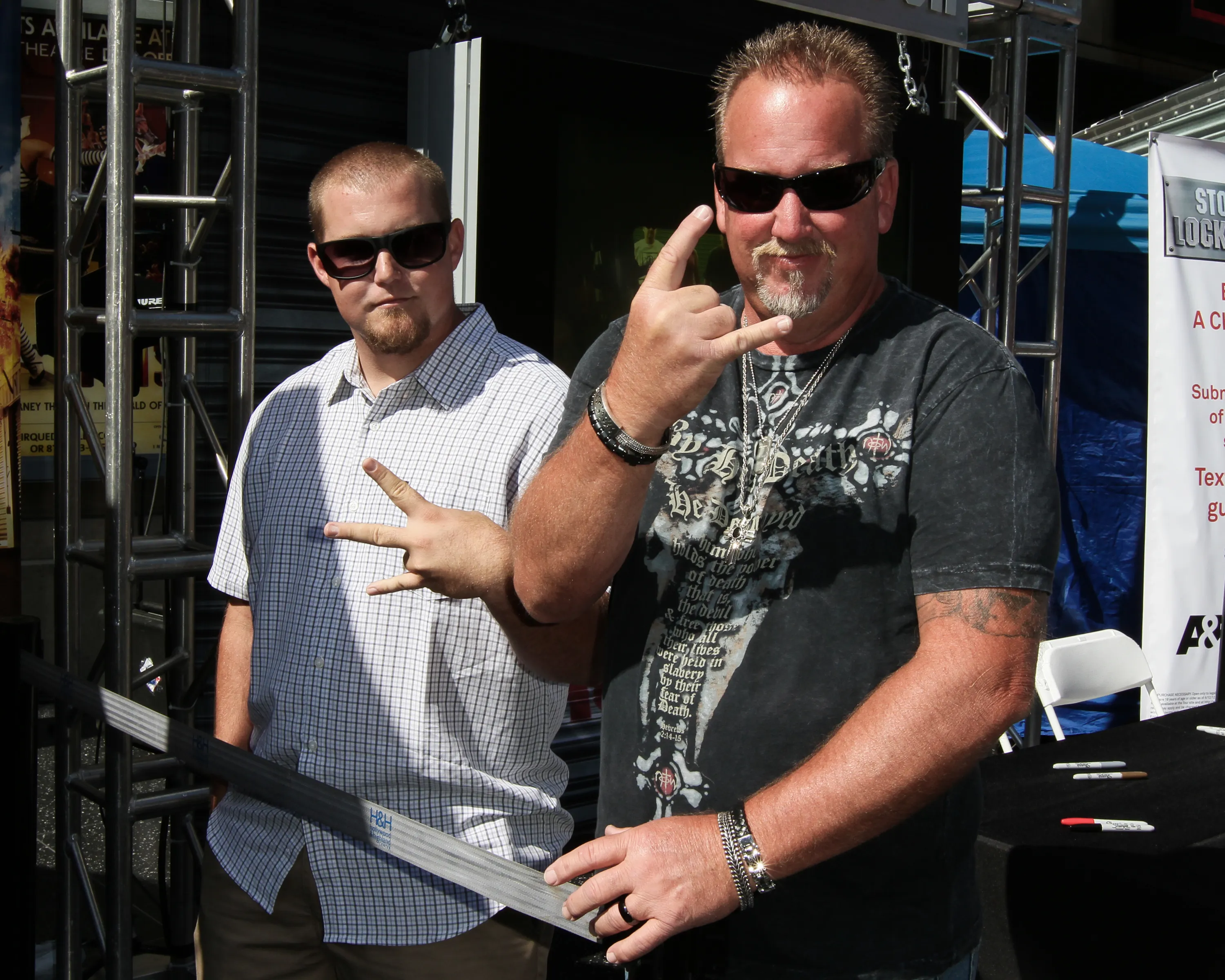 Darrell Sheets and Brandon Sheets from Storage Wars making hand gestures.