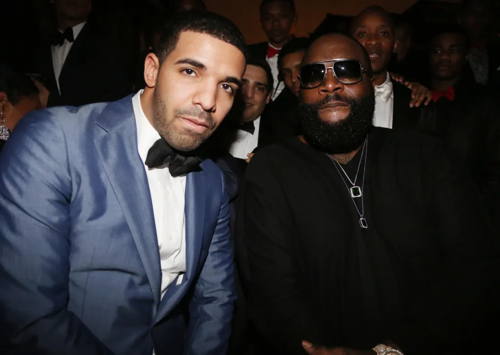 Rappers Drake and Rick Ross pose together at a party.