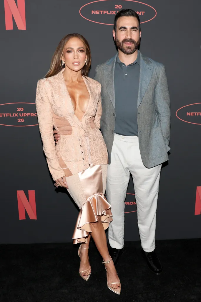 Jennifer Lopez and Brett Goldstein stand together at the 2026 Netflix Upfront event.