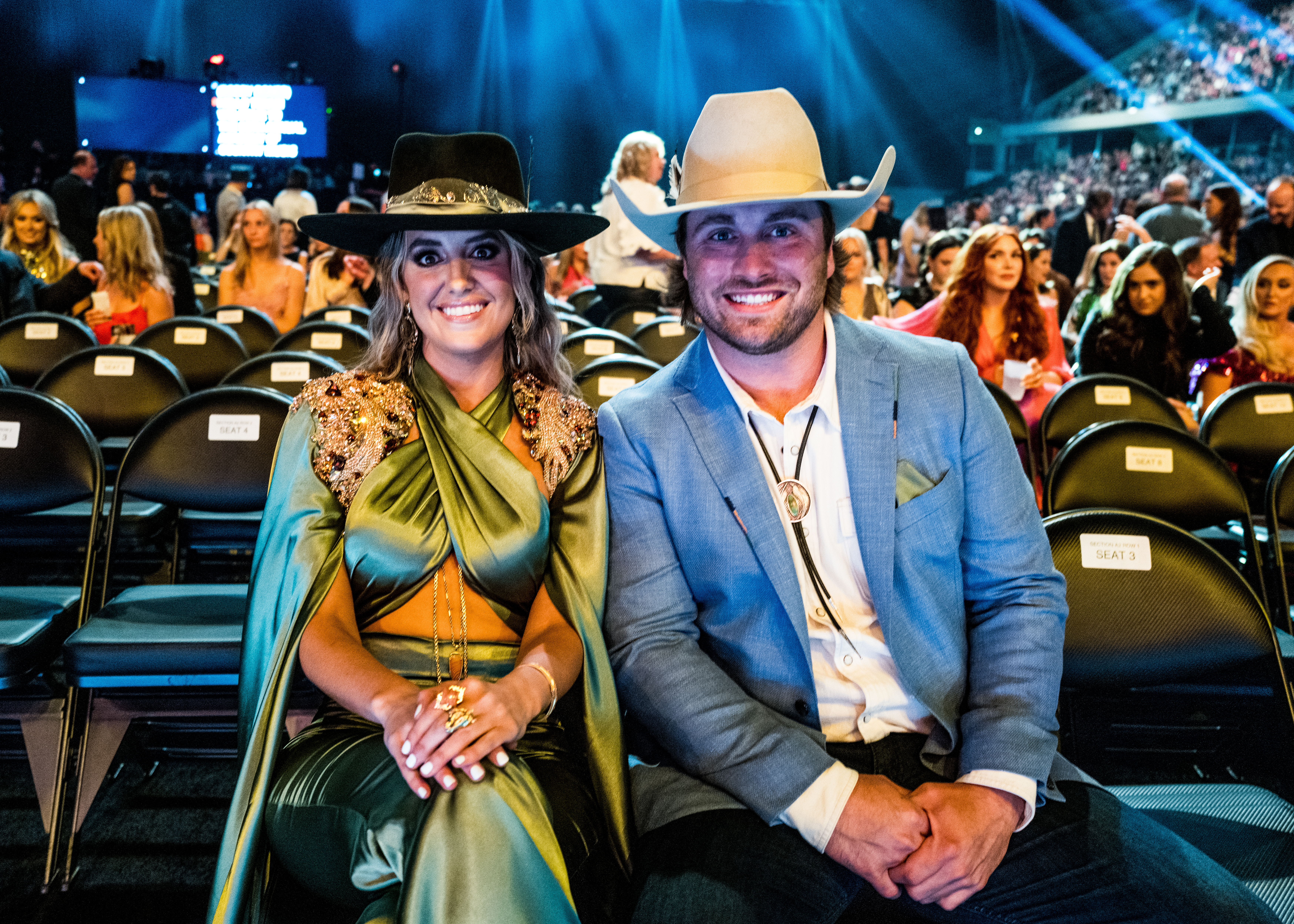 Lainey Wilson and Devlin Hodges smiling in formal attire.