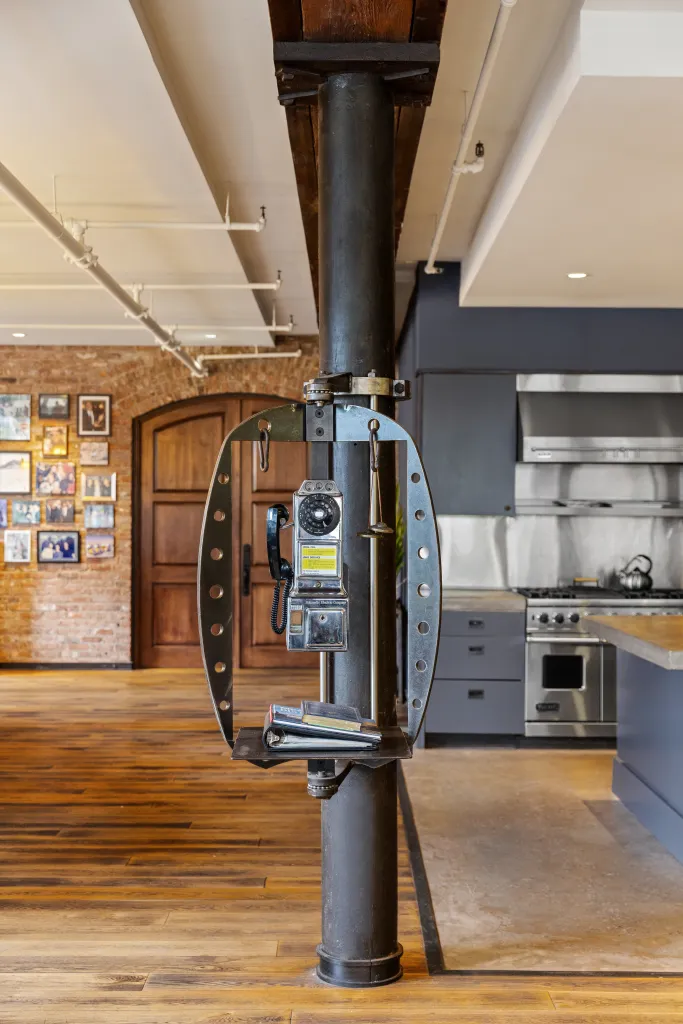 The owners filled the residence with unusual vintage and industrial elements, including real manholes embedded in the floor, a functioning 1953 phone booth used as the home phone, a bell once used to call a dog for dinner and a 1926 barber chair.
